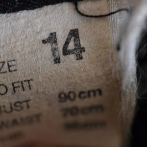 May include: A white tag with black text that reads "Size to fit Bust 90cm Waist 70cm" and the number "14" printed in large black font.