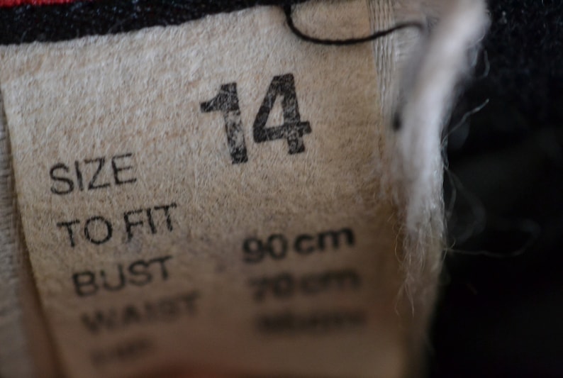 May include: A white tag with black text that reads "Size to fit Bust 90cm Waist 70cm" and the number "14" printed in large black font.