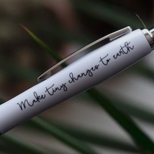 May include: White pen with a green cap and the text "Make tiny changes to earth" printed on the side.
