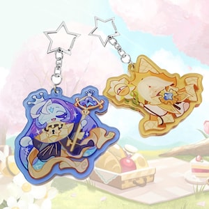 May include: Two acrylic keychains featuring cartoon characters with star-shaped silver clasps. One keychain displays a blue-haired character holding a golden key, while the other shows a yellow-haired character with a sun-like emblem and waffle patterns.
