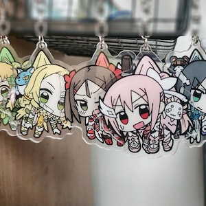 Pode incluir: Uma coleção de chaveiros de acrílico em estilo anime, apresentando personagens coloridos com olhos grandes e roupas detalhadas. Cada chaveiro é transparente com um anel de metal para fixação, mostrando uma variedade de designs e expressões únicas.
