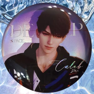 May include: A round button with a holographic finish featuring a portrait of a young man with black hair. The man is wearing a black jacket with blue accents. The text "DEEP SPACE" and "Caleb" are visible on the button.