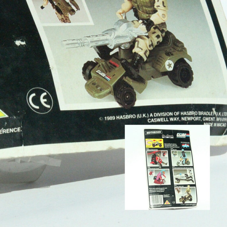 May include: A green and gray toy military vehicle with a large gun, a driver figure, and a star on the side. The vehicle is labeled "G.I. JOE" and "MOTORISED".