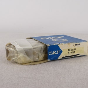 May include: A blue and white box with the text "SKF" on it. The box contains a bearing with the numbers "AK43131 K4331Z" on it.