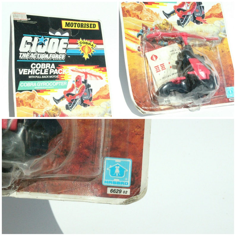 May include: A red and black Cobra Gyrocoptor toy with a pull-back motor. The toy is packaged in a plastic blister pack with a cardboard backing. The packaging features the G.I. Joe logo and the words "Cobra Vehicle Pack" and "Motorized".