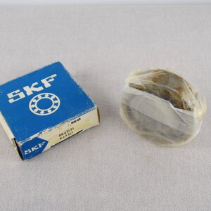 May include: A blue box with the SKF logo and the text "AK41131 K 43131" on it. The box contains a new SKF bearing, wrapped in clear plastic.