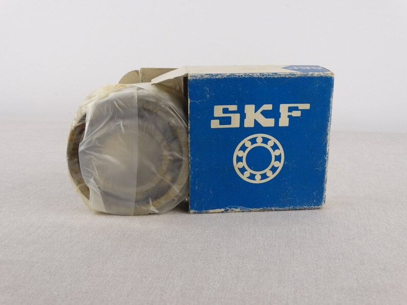 May include: A new, sealed, SKF ball bearing in a blue and white box. The box features the SKF logo and a drawing of a ball bearing.