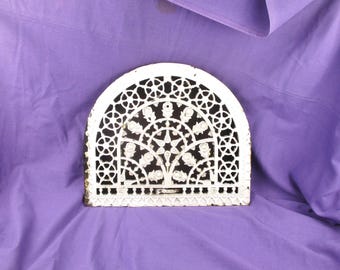 May include: White cast iron arched vent cover with a decorative floral design.