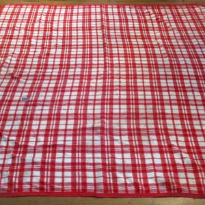 May include: Red and white checkered picnic blanket with red trim and handles.