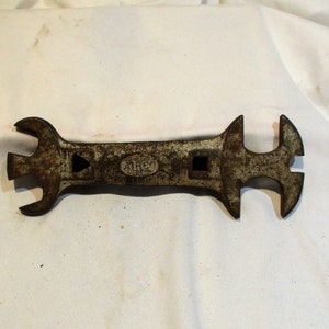May include: A vintage, rusty wrench with multiple openings. The wrench is marked "IRCO" on the handle.