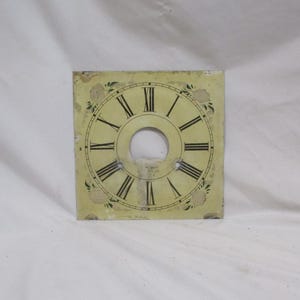 May include: A vintage clock face with Roman numerals, a yellow background, and green floral accents.