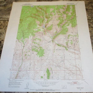 May include: A vintage topographic map of the Edmont, Mont. area. The map shows elevation contours, rivers, and other geographical features. The map is printed on a white background with brown and green lines.