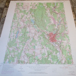 May include: A vintage topographic map of Putnam, Connecticut, showing the area around the town of Putnam. The map is printed in black, red, and green on white paper. The map includes roads, rivers, and other geographical features.