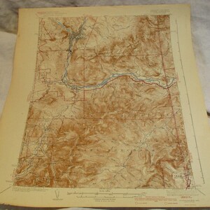 May include: An antique map of the area around Fairbanks, Alaska. The map is printed on cream-colored paper and features brown contour lines, blue rivers, and red lines indicating roads and boundaries. The map is titled "Fairbanks, Alaska" and includes a scale bar and a legend.