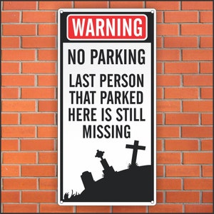May include: A rectangular metal sign with a red and white "WARNING" header. The sign reads "NO PARKING LAST PERSON THAT PARKED HERE IS STILL MISSING" with a graveyard silhouette at the bottom. The sign is mounted on a red brick wall.