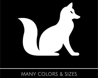 May include: A white silhouette of a fox sitting on its haunches against a black background. The fox has a bushy tail and pointed ears. Below the fox, the text reads "MANY COLORS & SIZES" with a color palette.