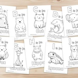 Peut inclure: Cartes d'alphabet noir et blanc avec des illustrations d'animaux. Chaque carte pr&eacute;sente une lettre, les mots "est pour", et un dessin simple d'un animal, comme un alligator, un ours, un chat, un dauphin, un &eacute;l&eacute;phant, un renard, une girafe, un hippopotame, un iguane et un jaguar.