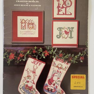 May include: A 1982 Christmas by Jinice charted designs pattern booklet featuring cross-stitch projects including a gingerbread house, NOEL and JOY signs, and two stockings with Santa Claus, reindeer, and gifts, with a holly garland border.