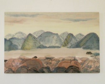 May include: A watercolor painting depicting a landscape with a series of blue and green mountains in the background and a foreground of brown and gray rocks.