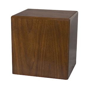 May include: A dark brown wooden box with a smooth, polished finish. The box is square and has a simple, elegant design.