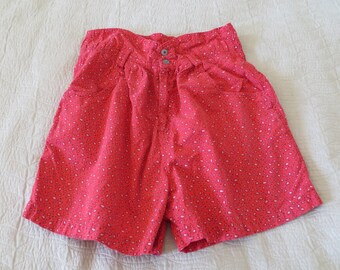 May include: Red high-waisted shorts with a white and pink floral print.