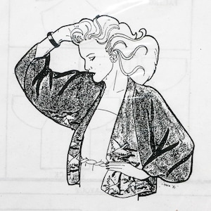 May include: A white package featuring a black and white illustration of a woman wearing a kimono-style jacket. The text "tombo patterns 1001" and "CHABAORI" are printed on the package. The package is sealed in clear plastic.