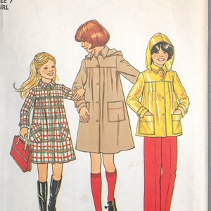 May include: Vintage Simplicity sewing pattern 7948 for girls' clothing. The pattern shows illustrations of a plaid dress, a beige coat, and a yellow raincoat with red trousers. The pattern is size 7.