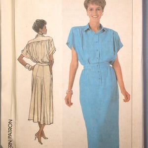 May include: A vintage Simplicity sewing pattern, size O (12+14+16), featuring a blue dress design with a button-down top and pencil skirt. The pattern includes a line drawing of the dress and the Simplicity logo.