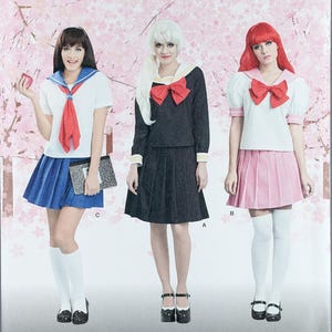 May include: Simplicity sewing pattern 8160 D5 for costumes in sizes 4-12. The envelope features three variations of sailor-style outfits with pleated skirts, short-sleeved tops, and large bows, displayed against a background of cherry blossom trees.