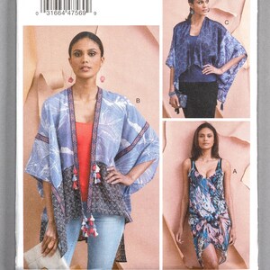 May include: A sewing pattern for three different garments. The pattern is for a sleeveless dress, a long-sleeved top, and a short-sleeved top. The pattern is from Vogue Patterns and is designed by Elizabeth Gillett. The pattern number is V9323.