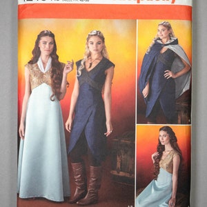 May include: Simplicity sewing pattern 1246 for sizes 14, 16, 18, 20, 22. The envelope features illustrations of a floor-length light blue dress with a gold bodice, a dark blue wrap-style dress, and a dark blue hooded cape with a light gray lining.