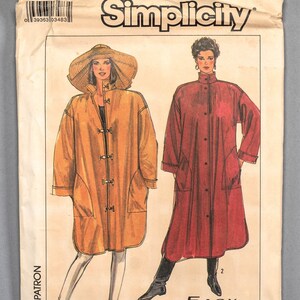 May include: Simplicity sewing pattern number 8443, size small, for a long coat with a button closure. The pattern shows two models wearing the coat in different colours, one in yellow and one in red.