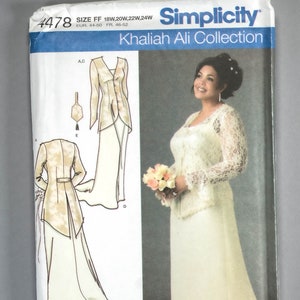 May include: Simplicity sewing pattern #4478 from the Khaliah Ali Collection. The pattern features a bridal gown with a lace bodice and long sleeves, and a matching jacket. The pattern includes sizes 18W, 20W, 22W, and 24W.