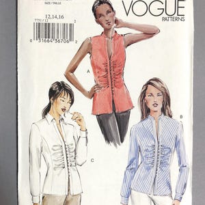 May include: Vogue Patterns sewing pattern 7751. The pattern features illustrations of three different blouses: a sleeveless coral top, a white button-down shirt, and a blue striped blouse. The pattern size is 12, 14, and 16.