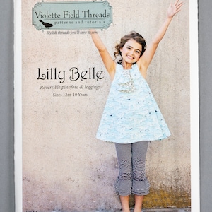 May include: A sewing pattern for a reversible pinafore and leggings for children, called "Lilly Belle". The pattern is from Violette Field Threads, a company that makes stylish threads you'll love to sew. The pattern is for sizes 12 months to 10 years.