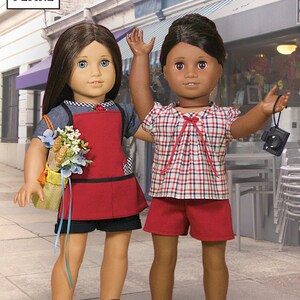 May include: Two dolls, one with brown hair and a red and white plaid shirt and red shorts, and the other with brown hair and a red apron over a blue and white striped shirt, standing in front of a cafe called "Le Bon Cafe".