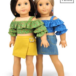 May include: Two dolls wearing off-the-shoulder tops and skirts. The doll on the left is wearing a green floral top and a yellow skirt. The doll on the right is wearing a blue floral top and a blue denim skirt. Both dolls are wearing sandals.
