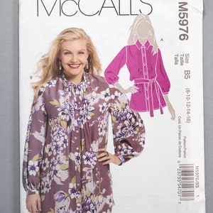 May include: A sewing pattern for a long-sleeved blouse with a floral print. The pattern is from McCall's and is size B5 (8-10-12-14-16).