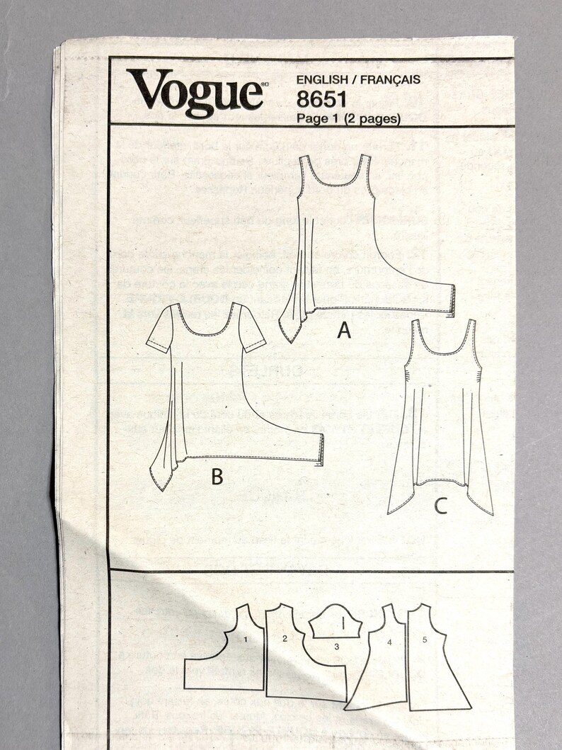 May include: A Vogue sewing pattern sheet with illustrations of three different garment designs labeled A, B, and C. The pattern includes the number 8651 and the text "Page 1 (2 pages)". The sheet also shows pattern pieces numbered 1 through 5.