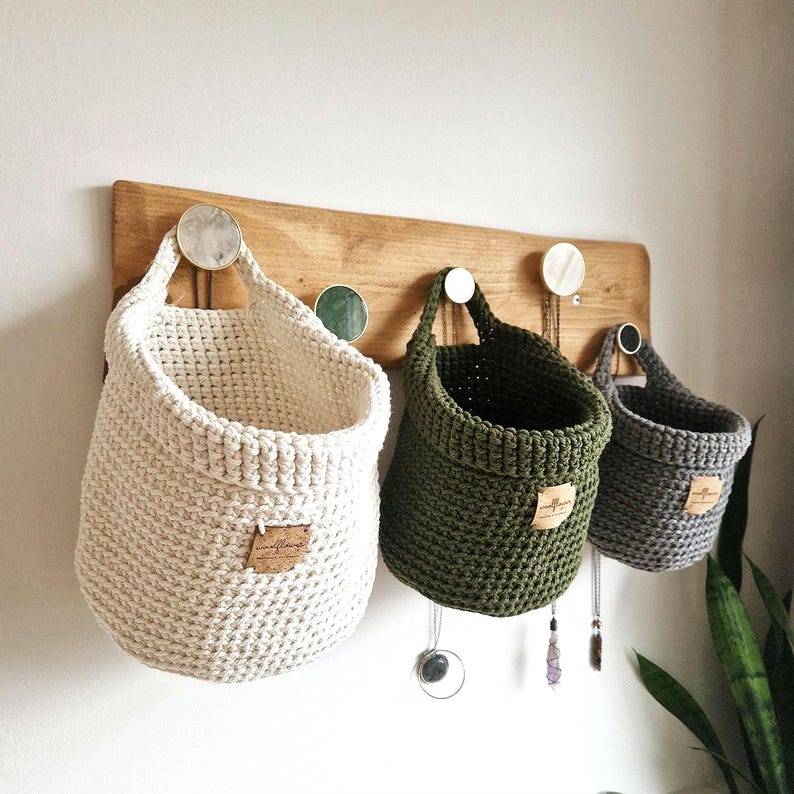 Natural, olive green and grey coloured crochet hanging storage baskets in small, medium and large. Great for nursery, bathroom, bedroom and hallway organisation and storage. Made by WoolflowerDesigns on Etsy