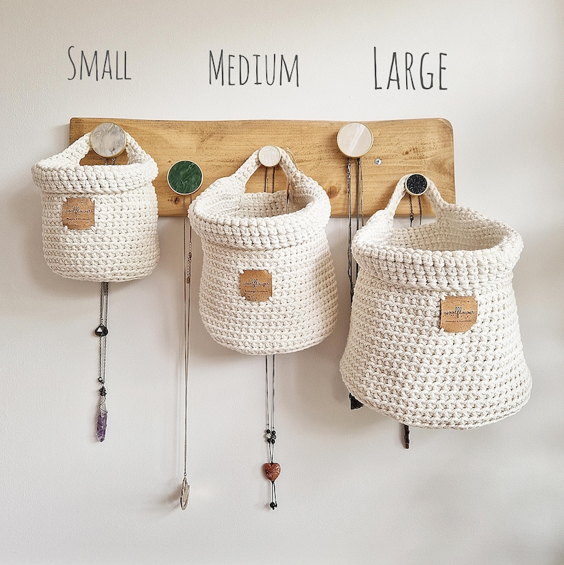 3 natural coloured crochet hanging storage baskets in small, medium and large. Great for nursery, bathroom, bedroom and hallway organisation and storage. Found on Etsy, by Woolflower