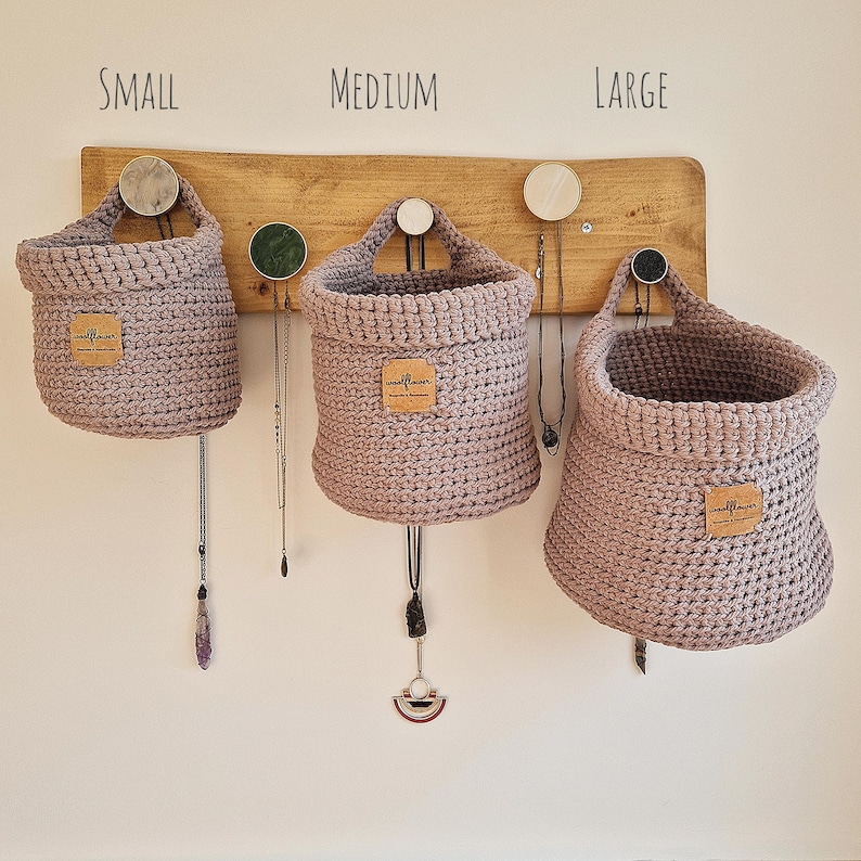 Warm grey crochet hanging baskets, perfect storage for organising bedrooms, bathrooms, kitchens and nurseries, on Etsy by Woolflowerdesigns. A great new home and house warming gift.