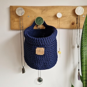 A navy blue cotton sample to make in to hanging crochet baskets with a vegan friendly cork "woolflower" logo. Great for bedrooms, bathrooms and nursery for storing toiletries, make-up, vitamins, pegs, etc. Natural home organisation on Etsy by Woolflowerdesigns!