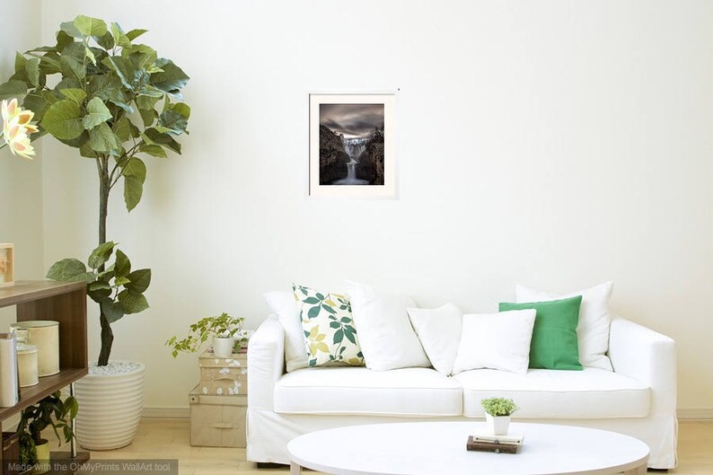 May include: A framed photograph of a waterfall cascading down a rocky cliff. The image is in black and white and has a vintage feel.