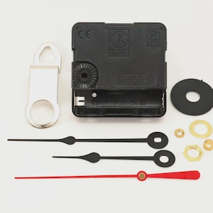 May include: Clock movement kit with black clock hands, a red second hand, and various hardware. Includes a black clock motor, a silver hanger, and a black rubber washer. Ideal for DIY clock projects.
