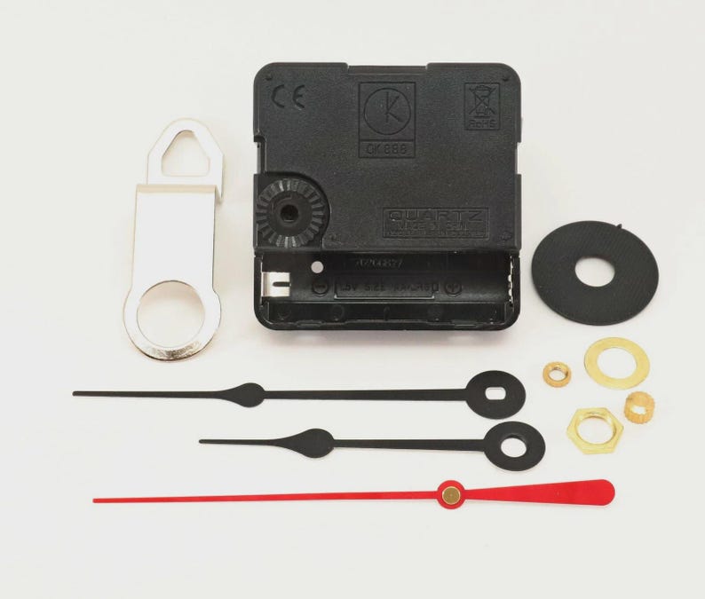 May include: Clock movement kit with black clock hands, a red second hand, and various hardware. Includes a black clock motor, a silver hanger, and a black rubber washer. Ideal for DIY clock projects.