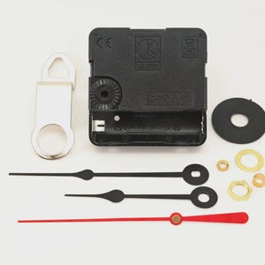 May include: Clock movement kit with black clock hands, a red second hand, and various hardware. Includes a black clock motor, a silver hanger, and a black rubber washer. Ideal for DIY clock projects.