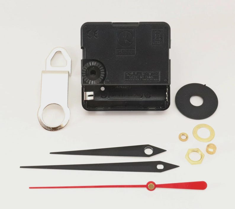 May include: Clock movement kit with black clock hands, a red second hand, and various hardware components. Includes a black clock motor, a silver hanger, and a black rubber washer. Ideal for DIY clock projects.