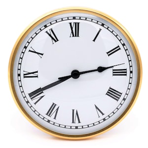 May include: A gold-framed clock with Roman numeral markings on a white face. The clock hands are black and point to the time of 3:00.