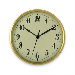 May include: A gold-framed clock with black hands and black Roman numeral markings on a light green face.